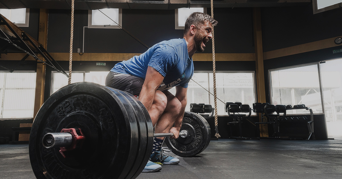 a man lifting weights in a gym