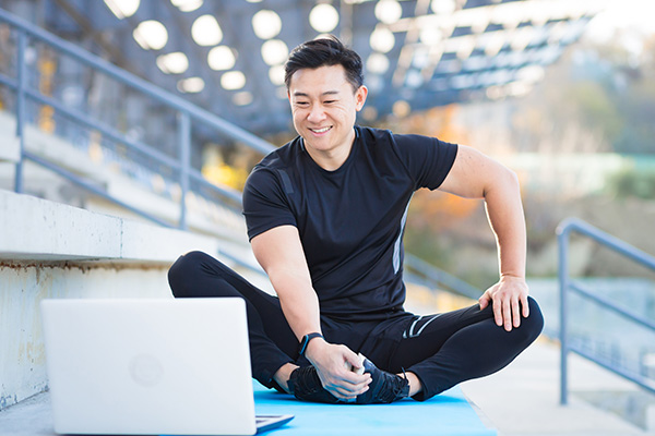 a man sitting on a mat with his legs crossed