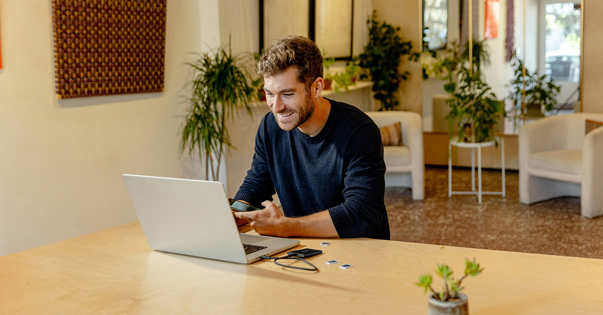 a man sitting at a table with a laptop