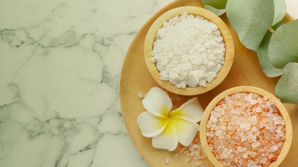 Bath salts and a frangipani flower