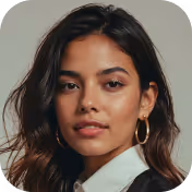 Portrait of a woman with long dark hair wearing hoop earrings and a white-collared black top.