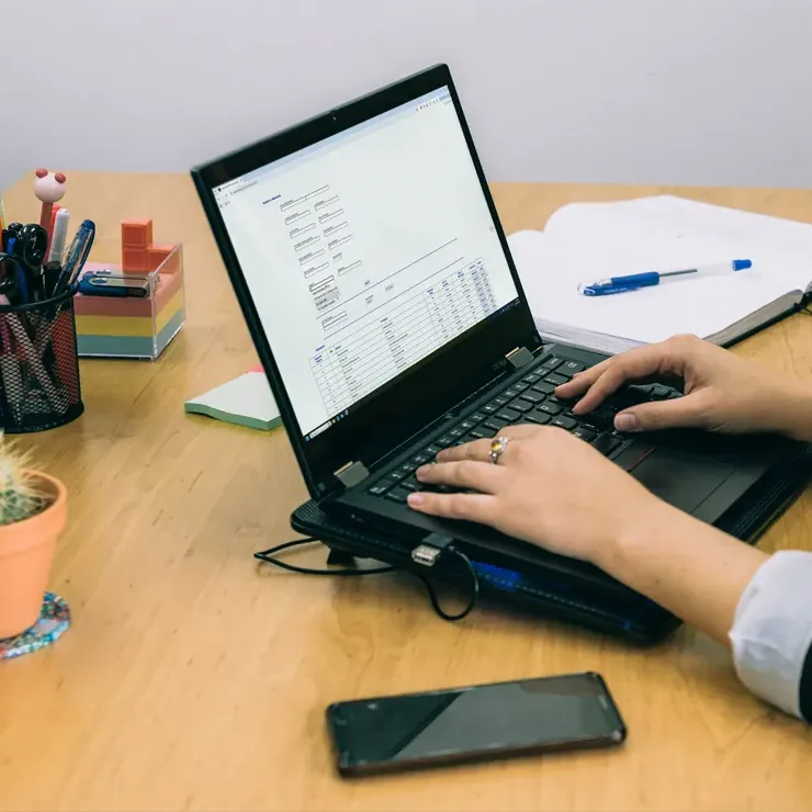 Person on a laptop searching for shipments on intertradedocs.com.