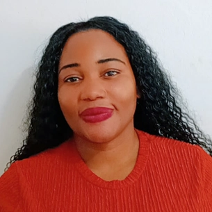 Portrait of Jackie Suka, administration and training lead at Intertradedocs, smiling in front of a plain grey background.