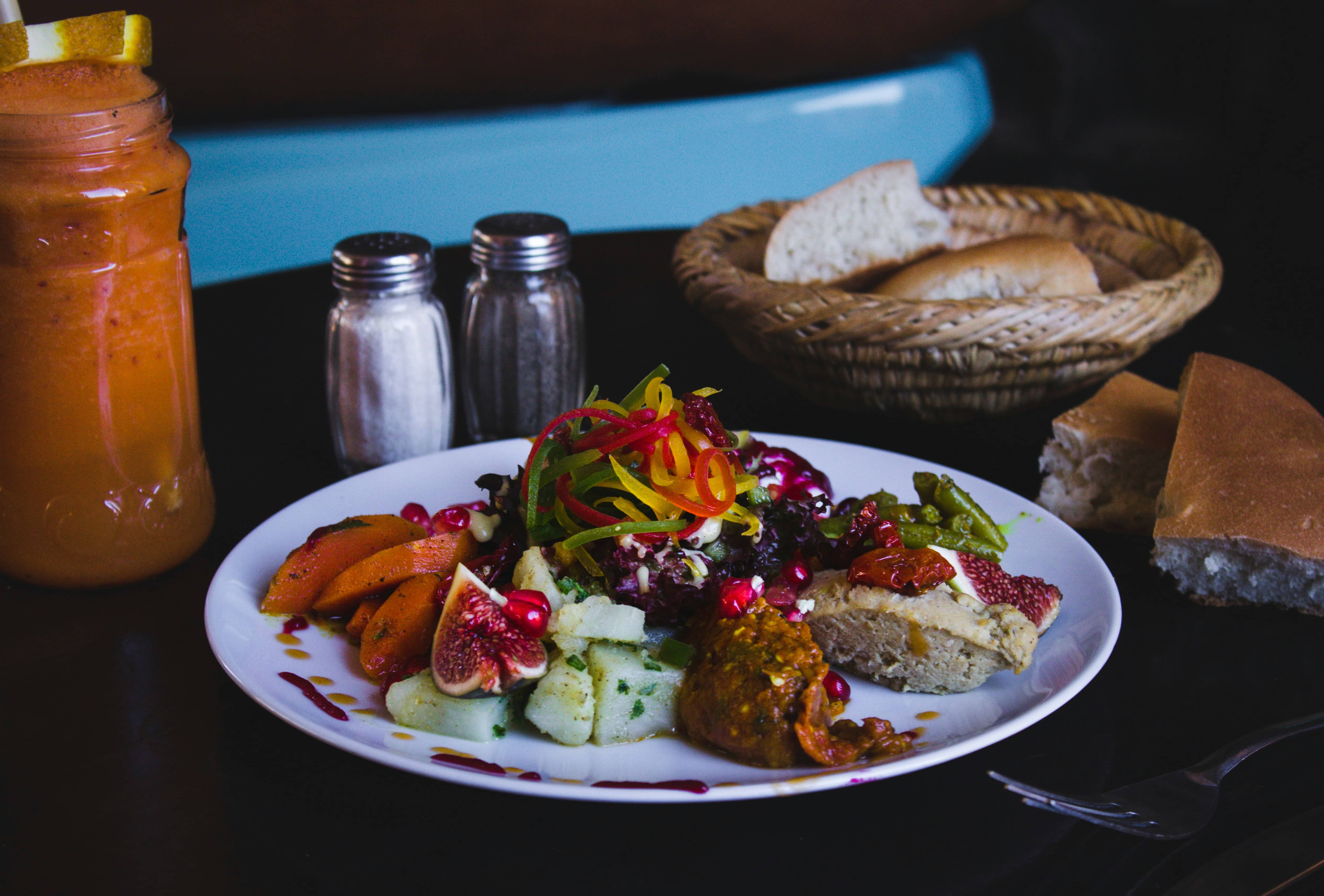 A mezze plate with dips, salad and bread on a restaurant table