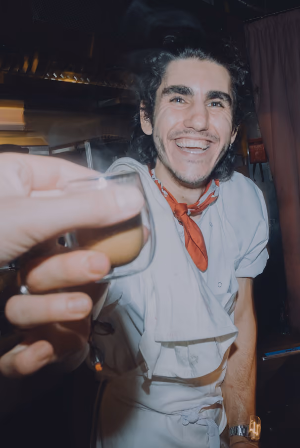 Chef Pamir Zeydan smiling at the pass