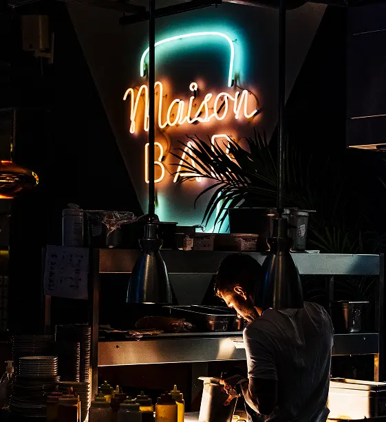 Chef at the open kitchen under the Maison Bab neon sign, Le Bab Covent Garden