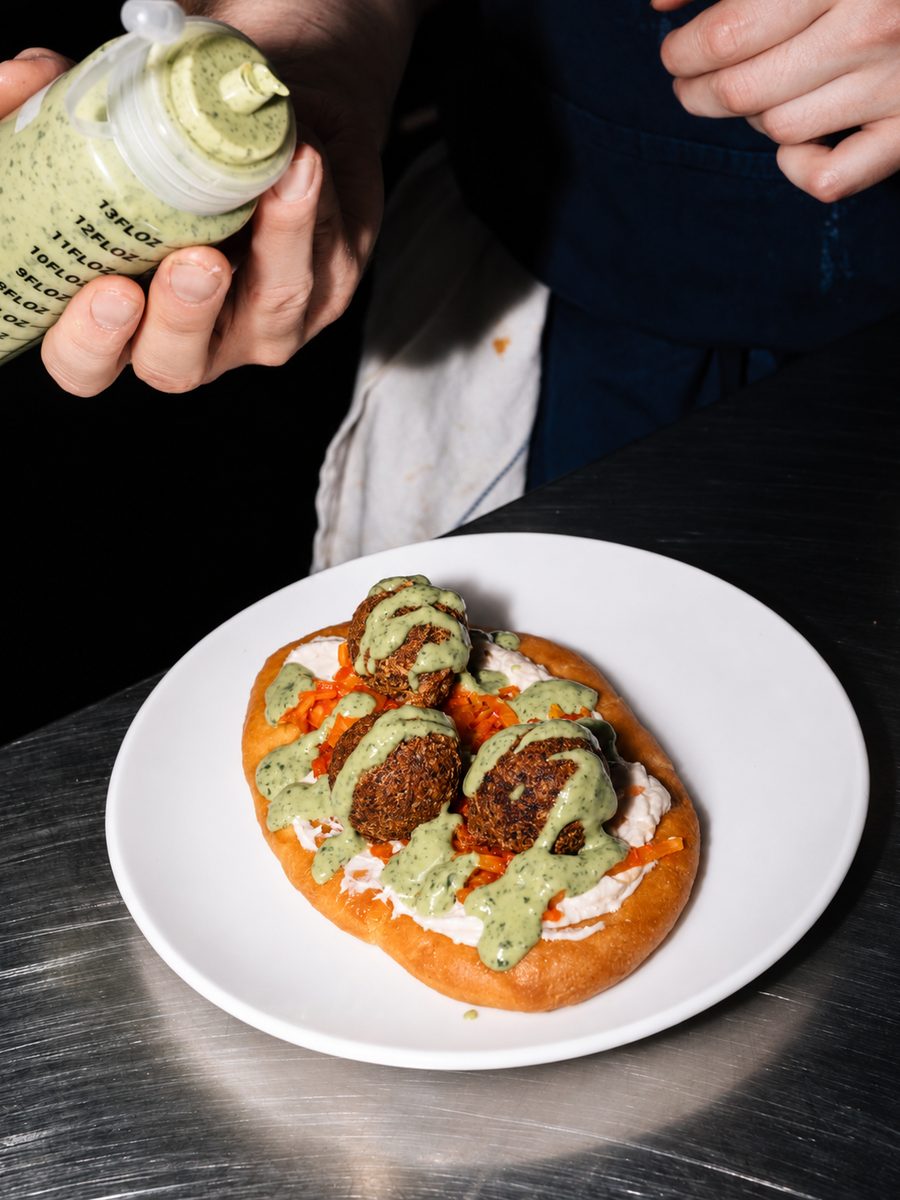 Herb mayo squeezed over a falafel kebab