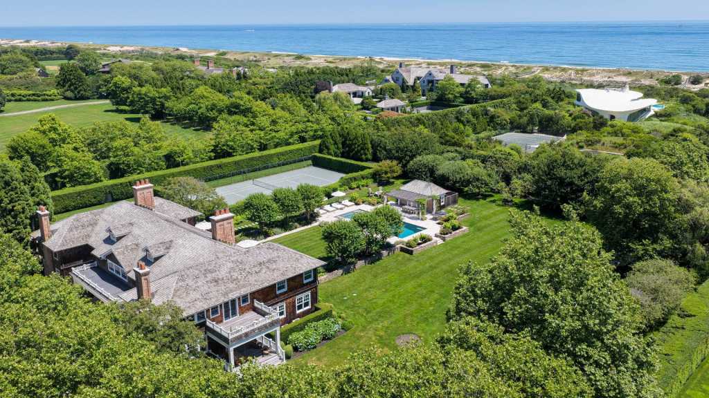 Shingle-style estate behind a hedgerow on Lily Pond Lane in East Hampton Village.