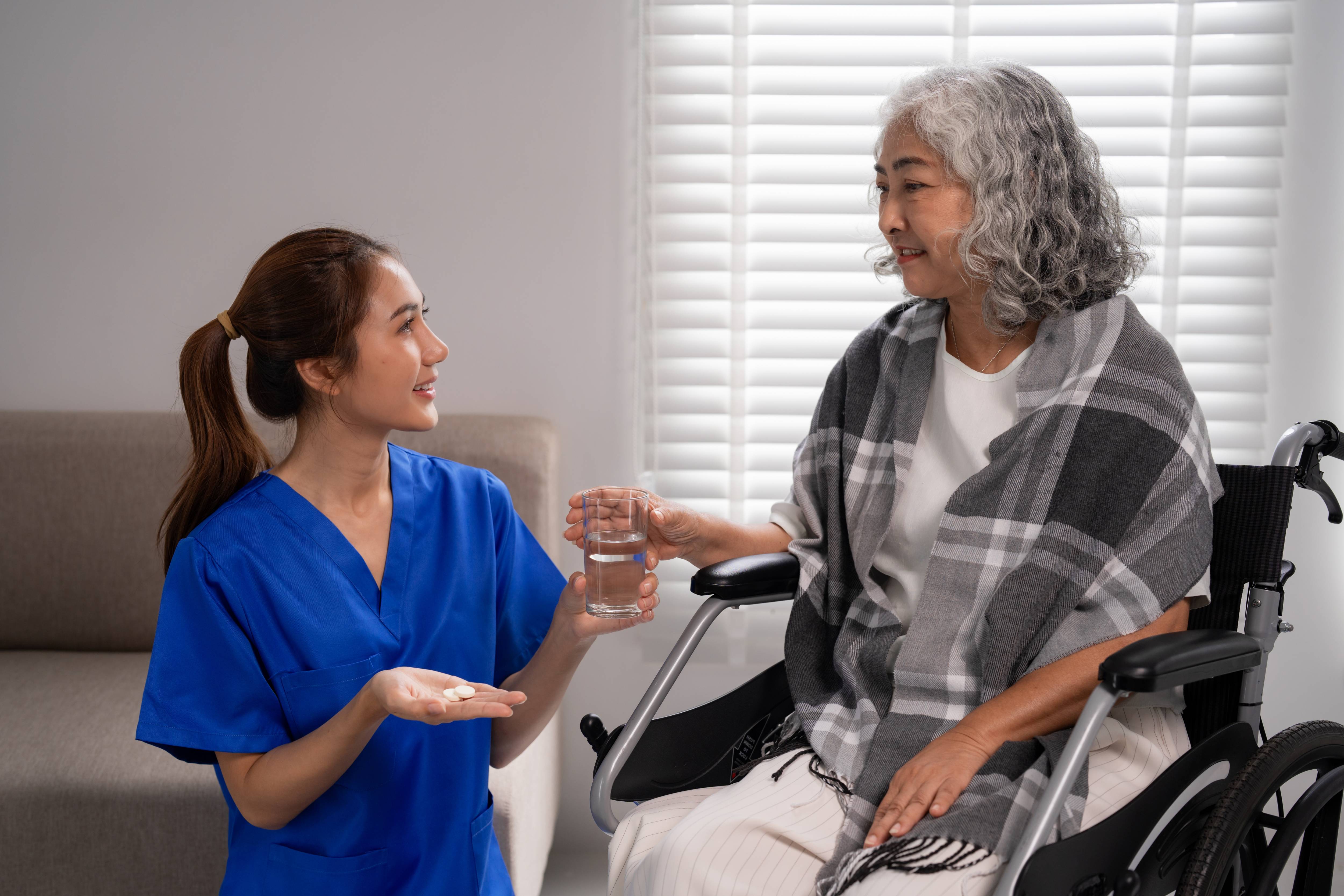Leader In Adult Care worker caring for a patient as part of their apprenticeship training.