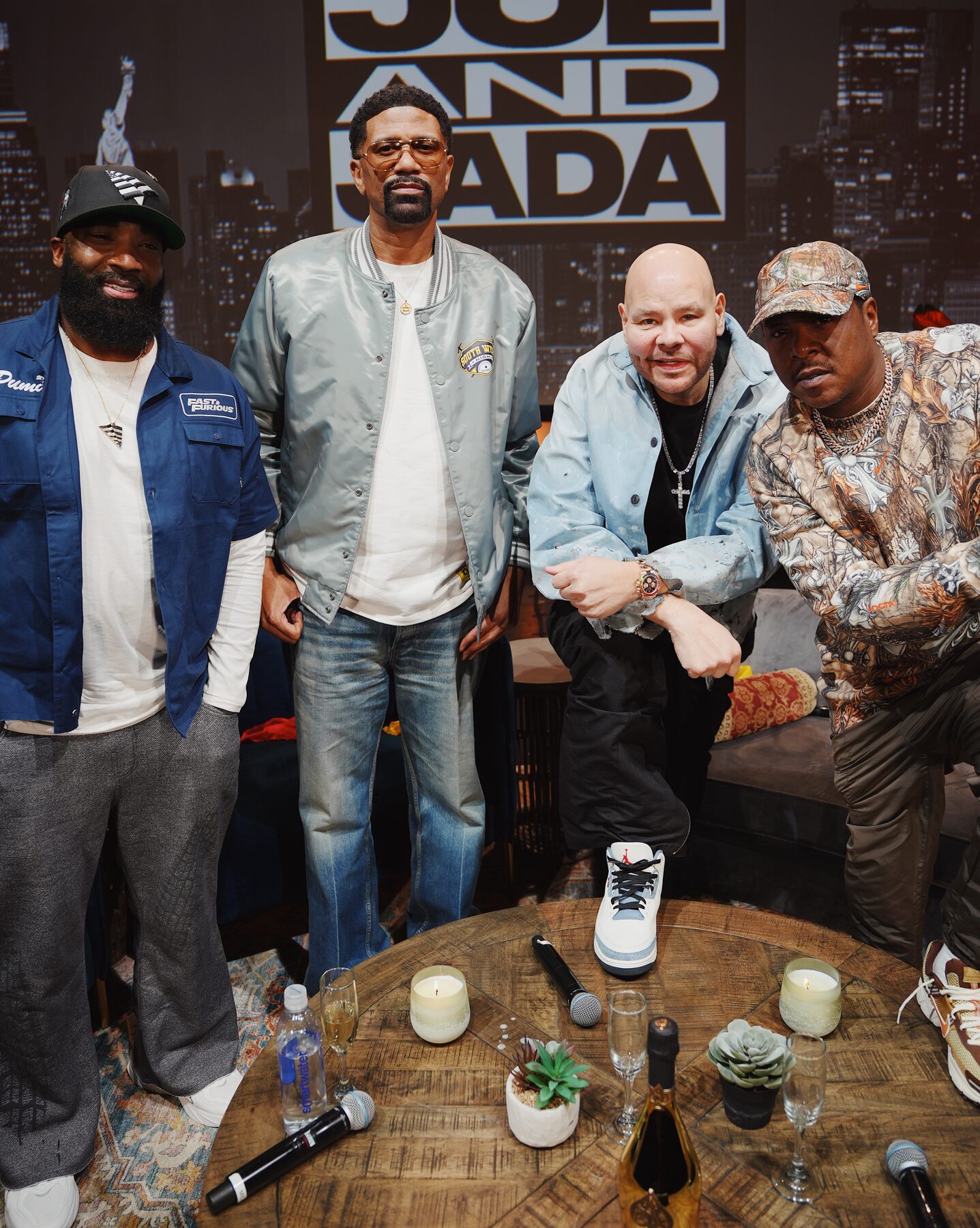 The full group around the table after the taping