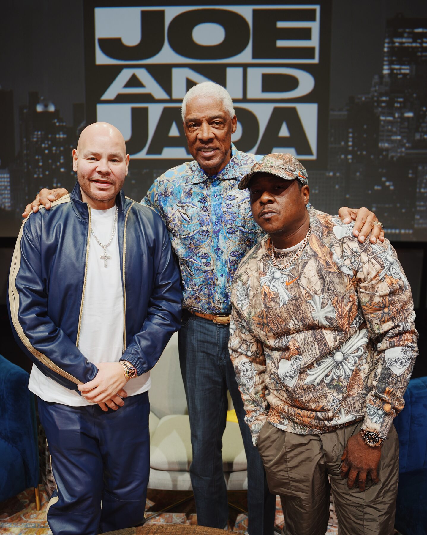 Hosts and guest posing together on set