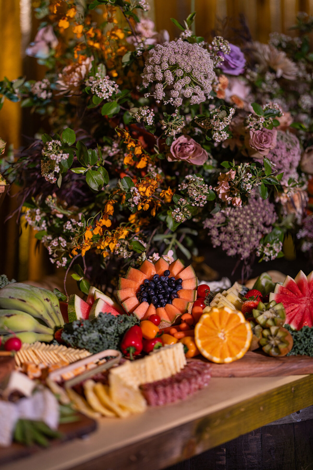 Charcuterie and fruit laid out along the table