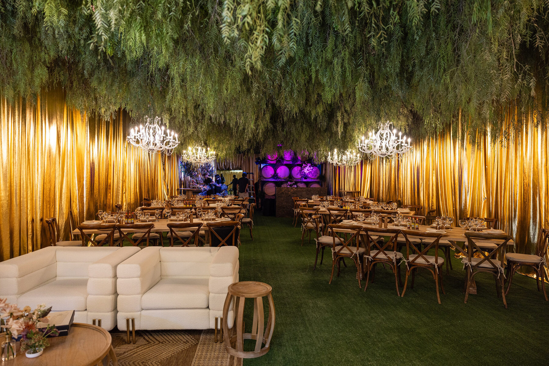 Long communal tables and lounge seating under the greenery