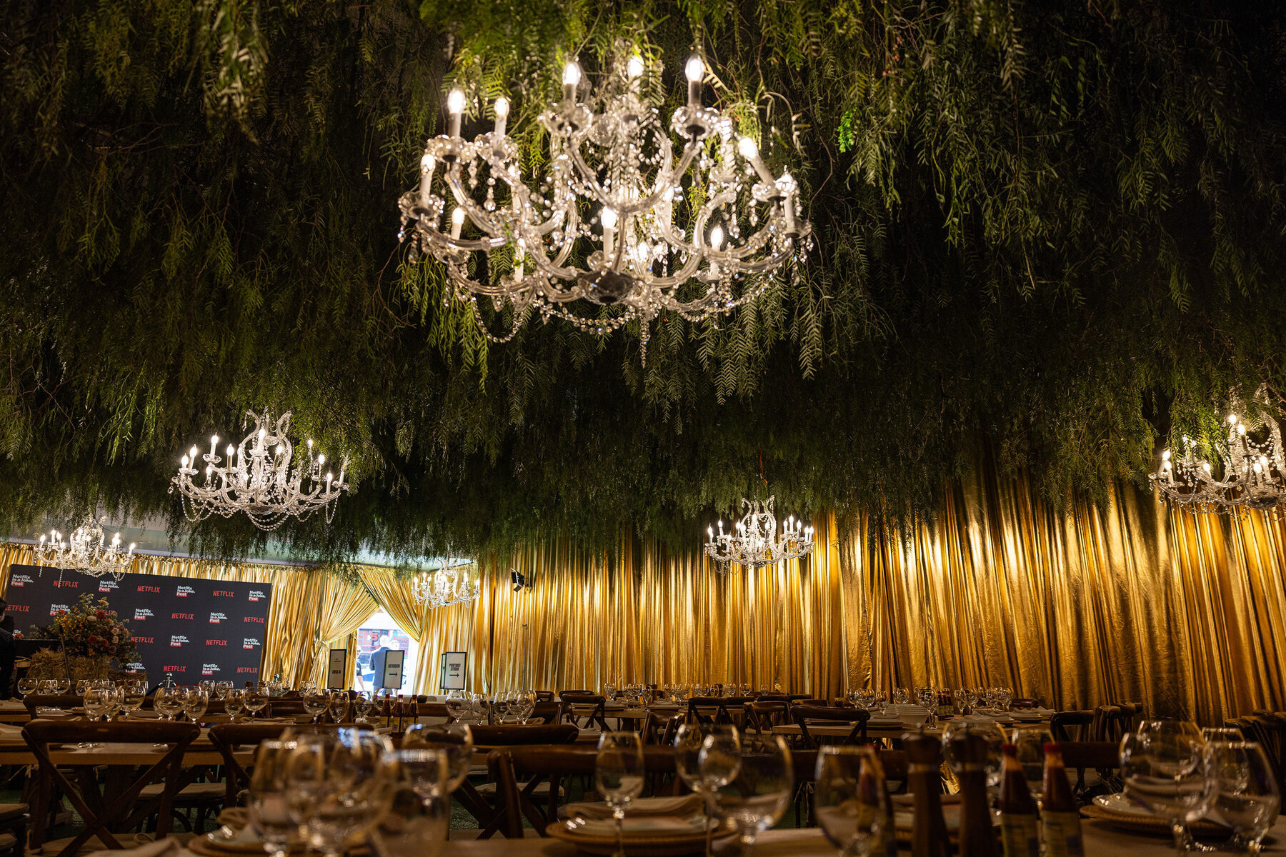Chandeliers hanging over the gold fringe walls