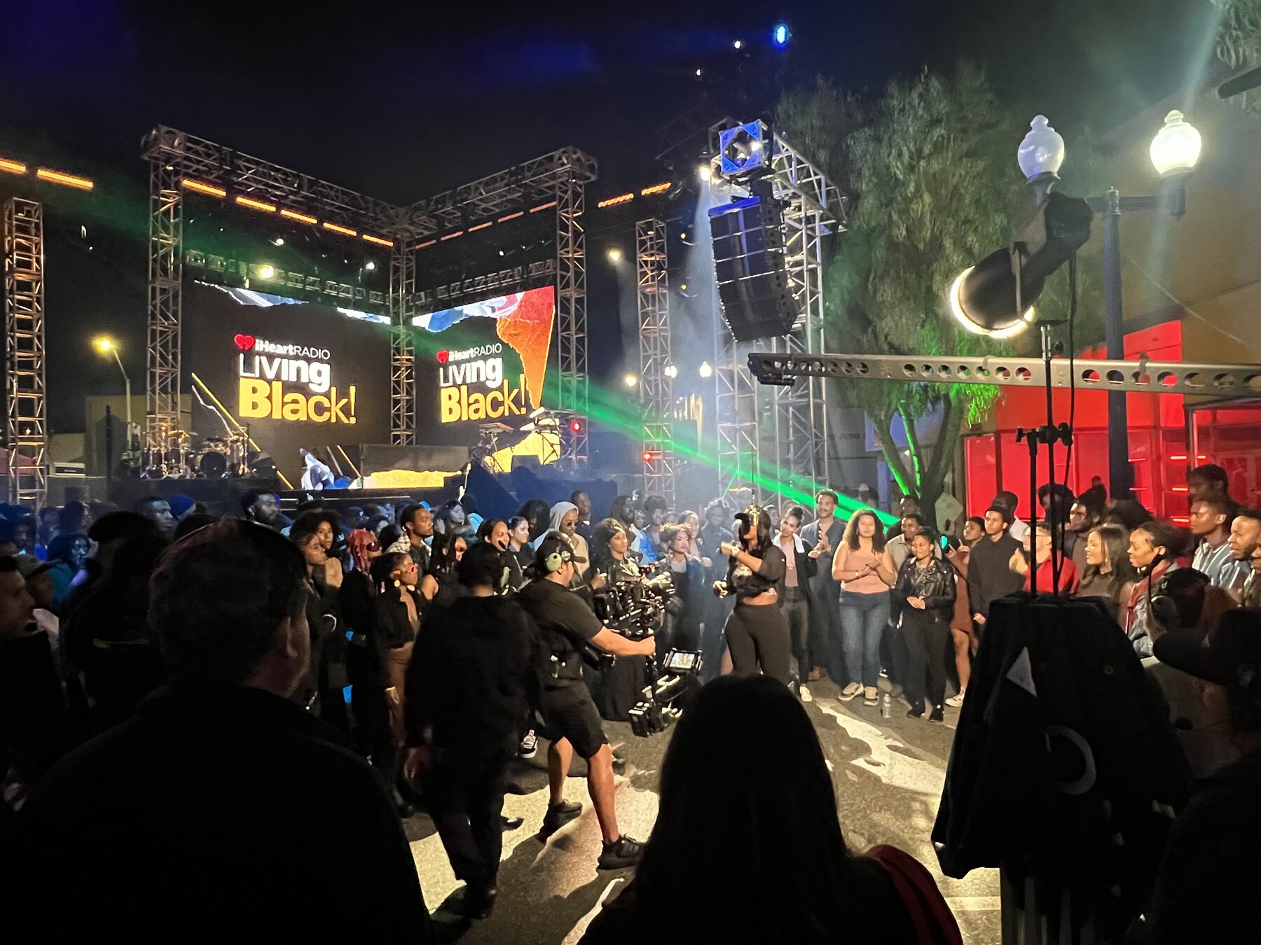 Crowd and lasers in front of the outdoor stage