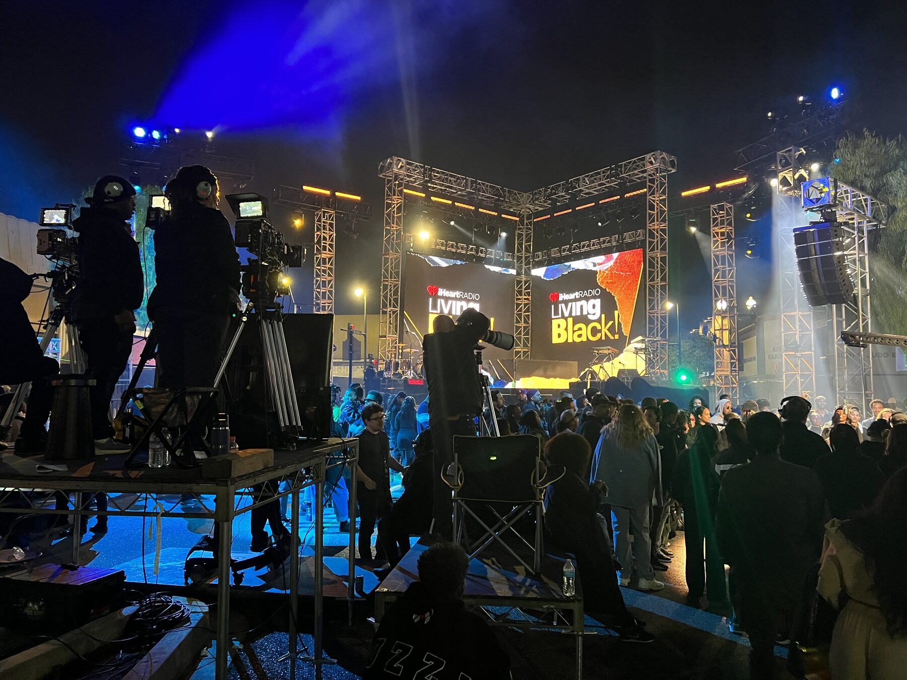Audience filling the street in front of the LED wall