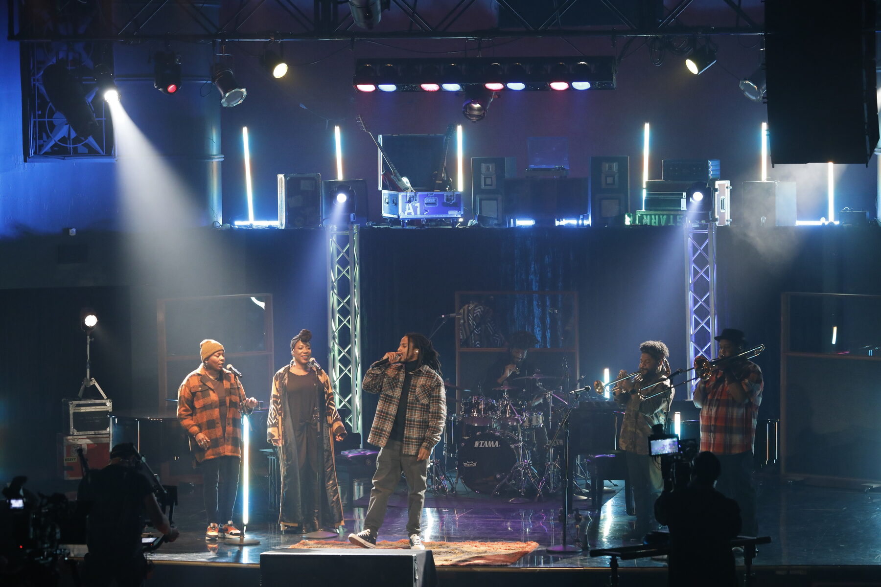 The band lit on the rebuilt stage during the taping