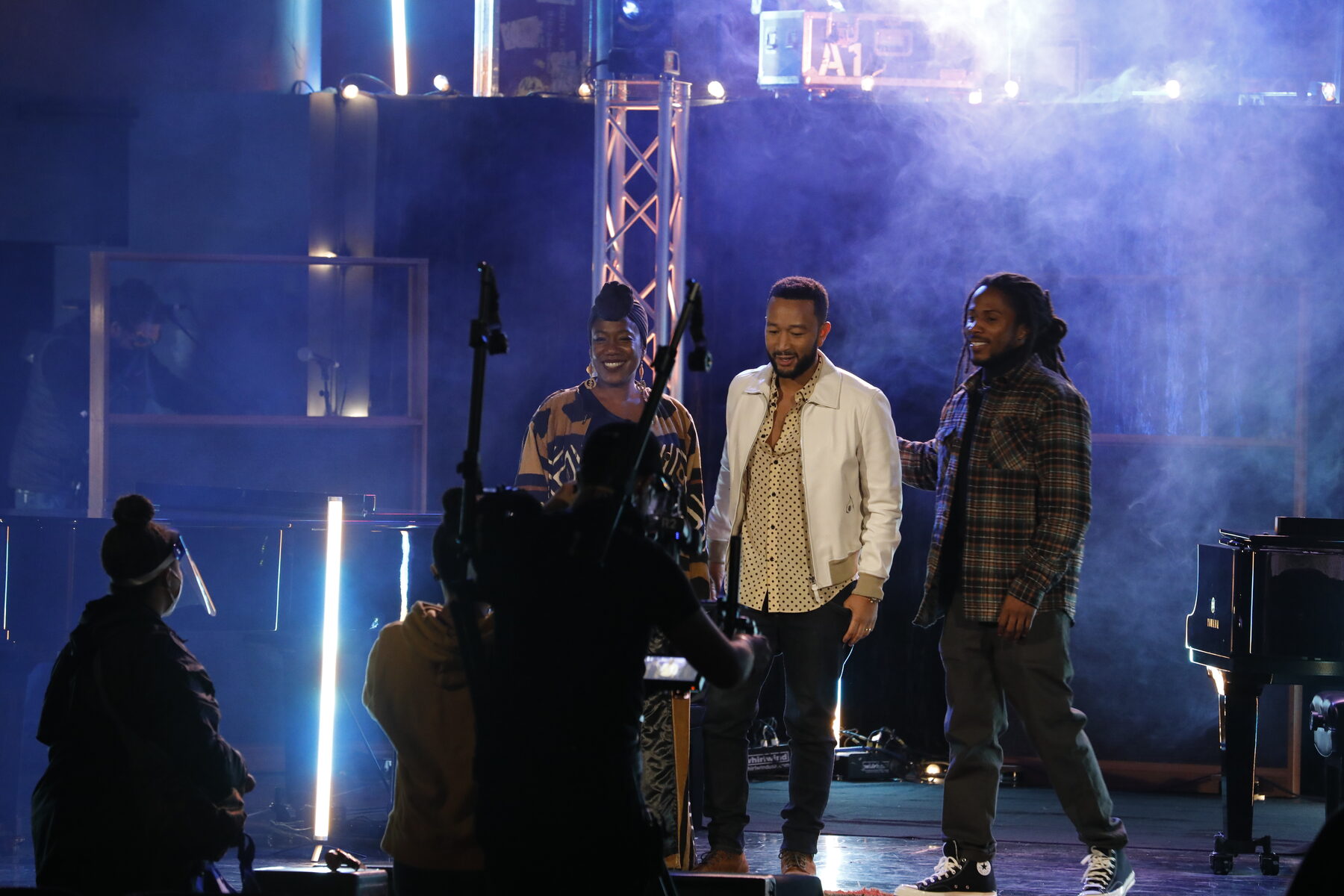 Two artists talking through a take on stage