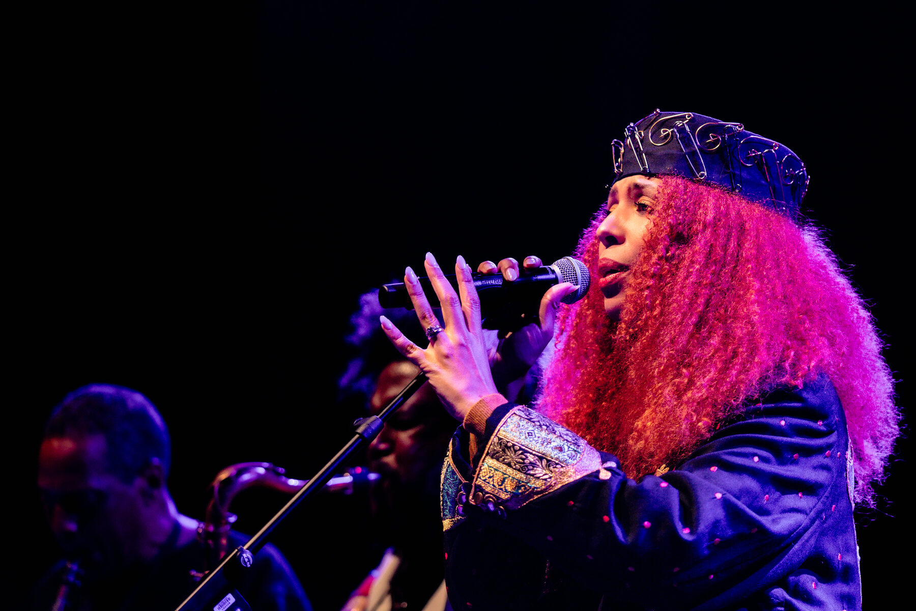 Vocalist lit in magenta during the finale
