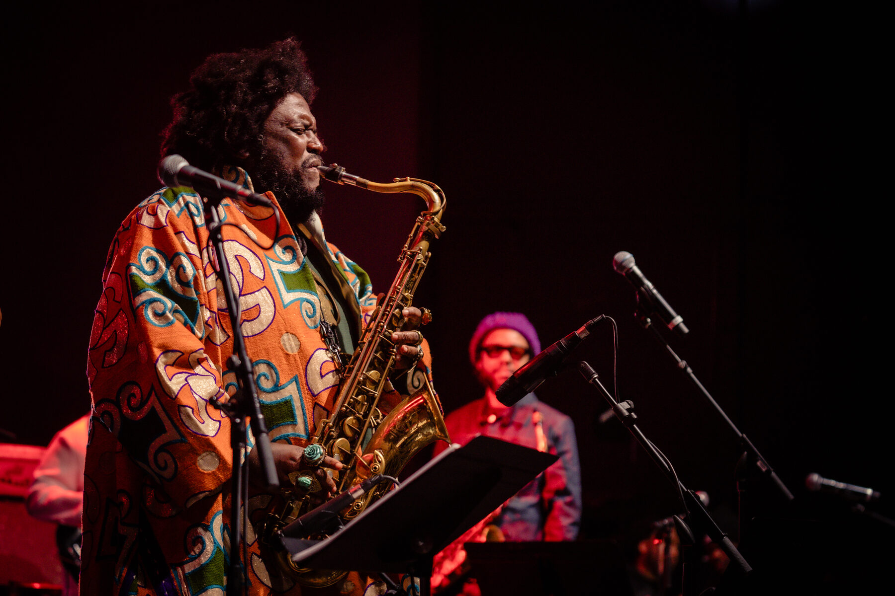 Kamasi Washington and a vocalist sharing the mic