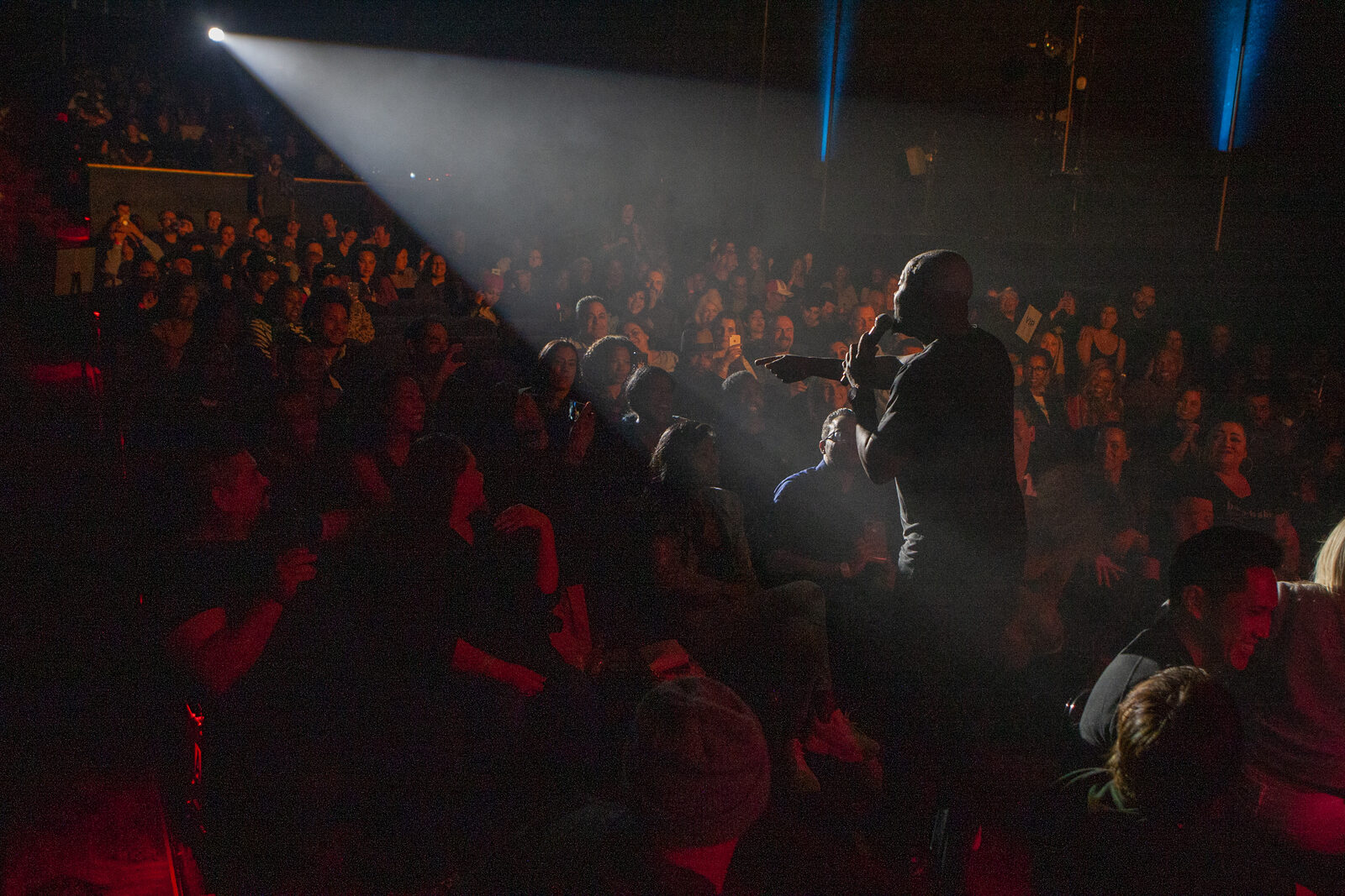 Spotlight beam over the audience during a show