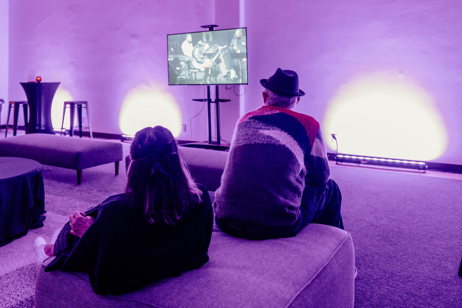 Guests watching the stage feed from the lounge sofas