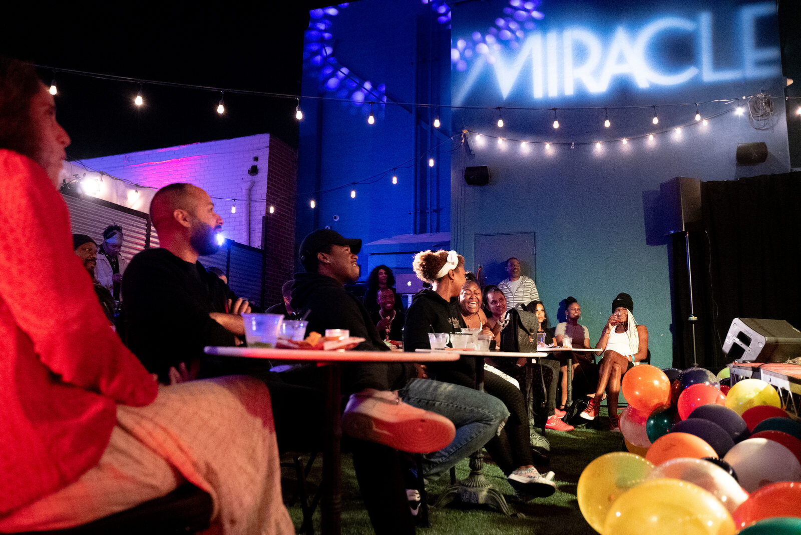 Guests at tables during a backyard show