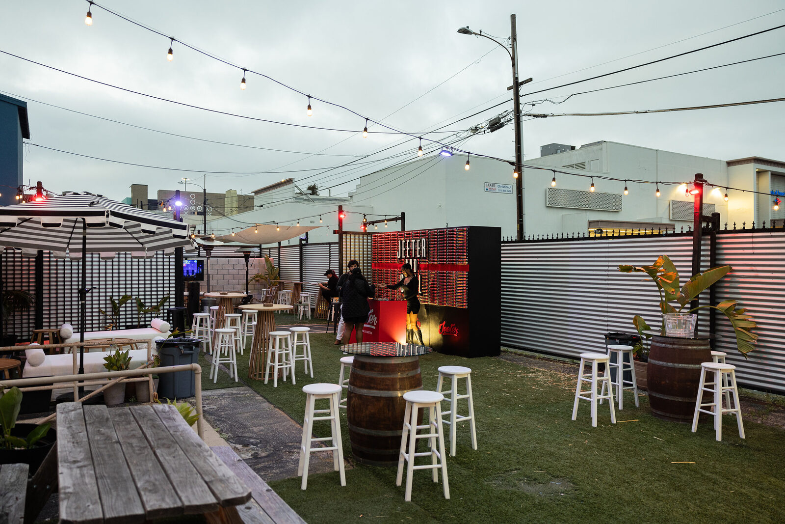 Backyard patio at dusk with string lights and lounge seating