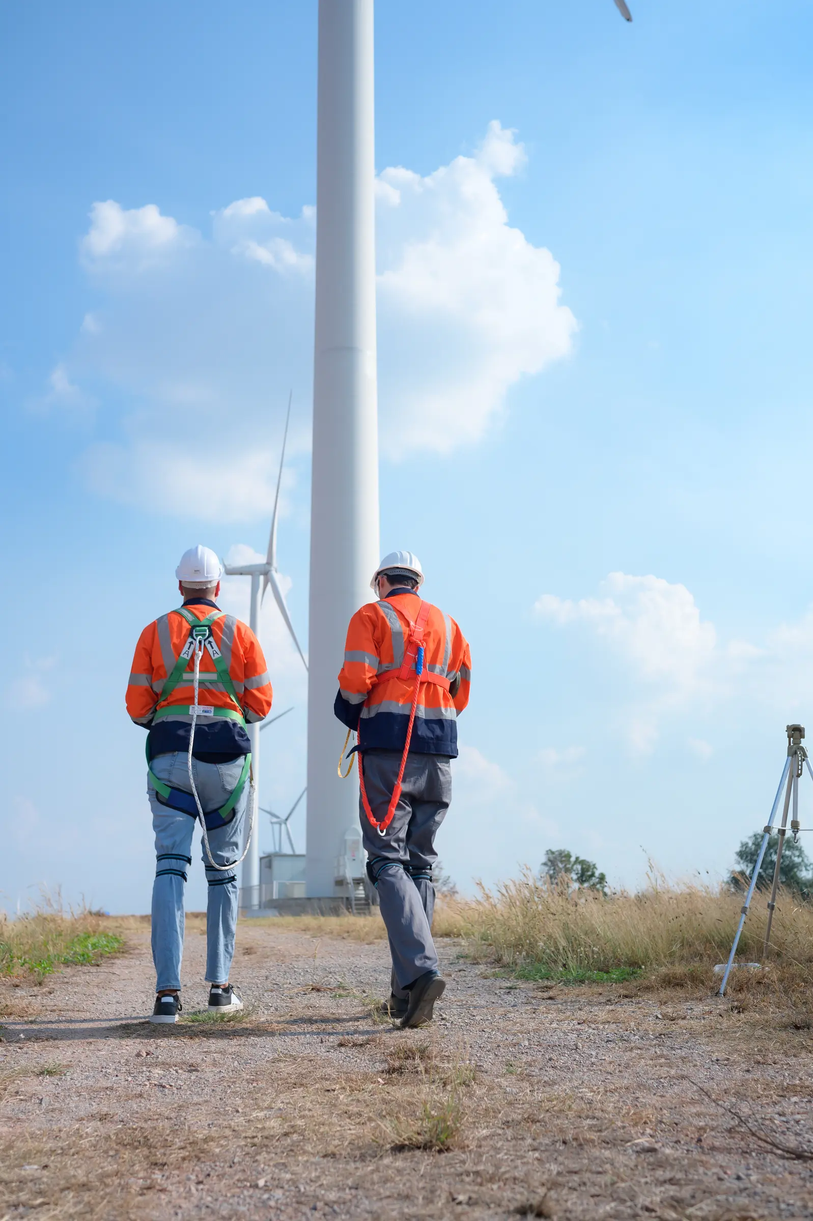 Surveyors inspecting infrastructure at a wind energy site.