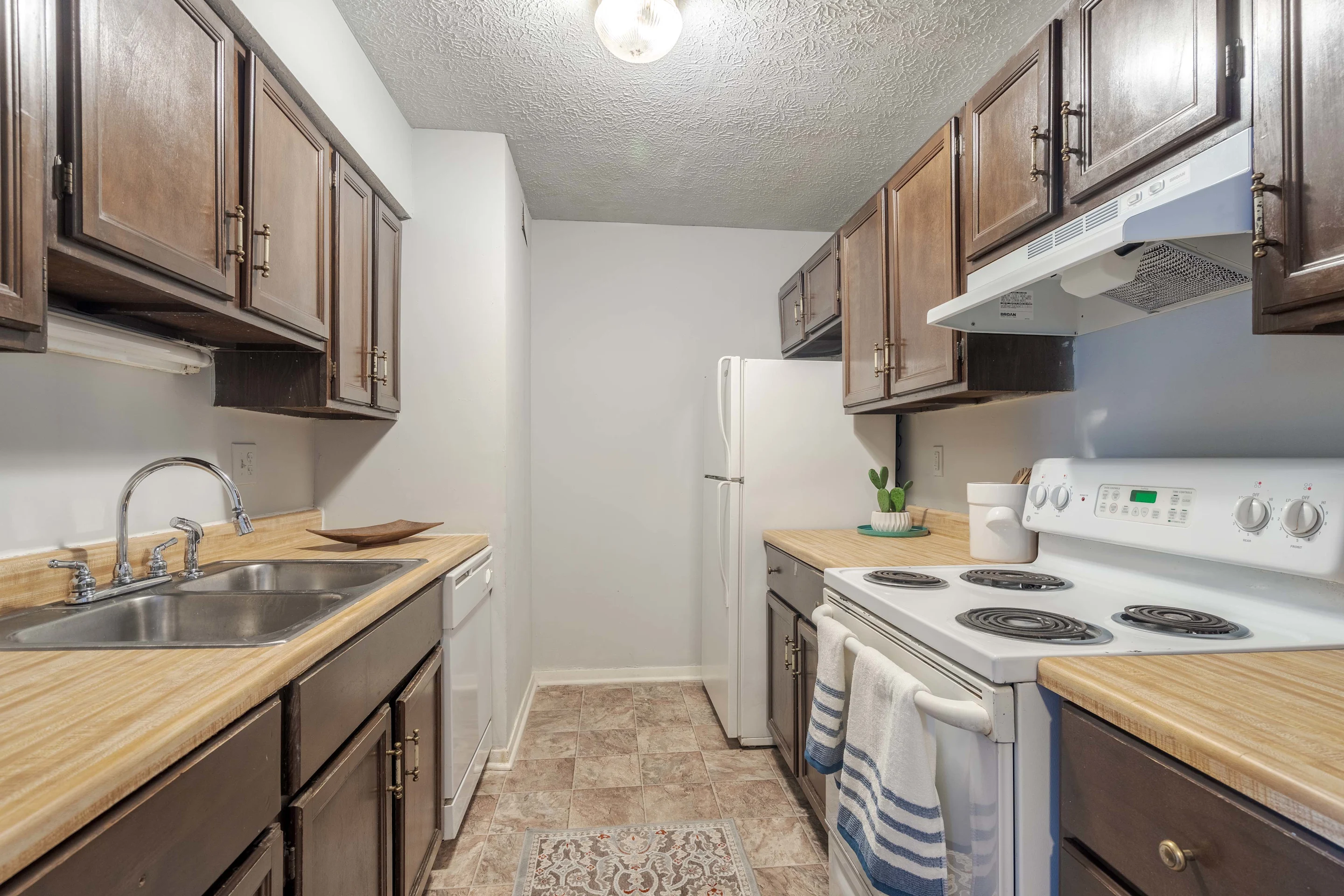 Kitchen with white appliances and brown cabinets