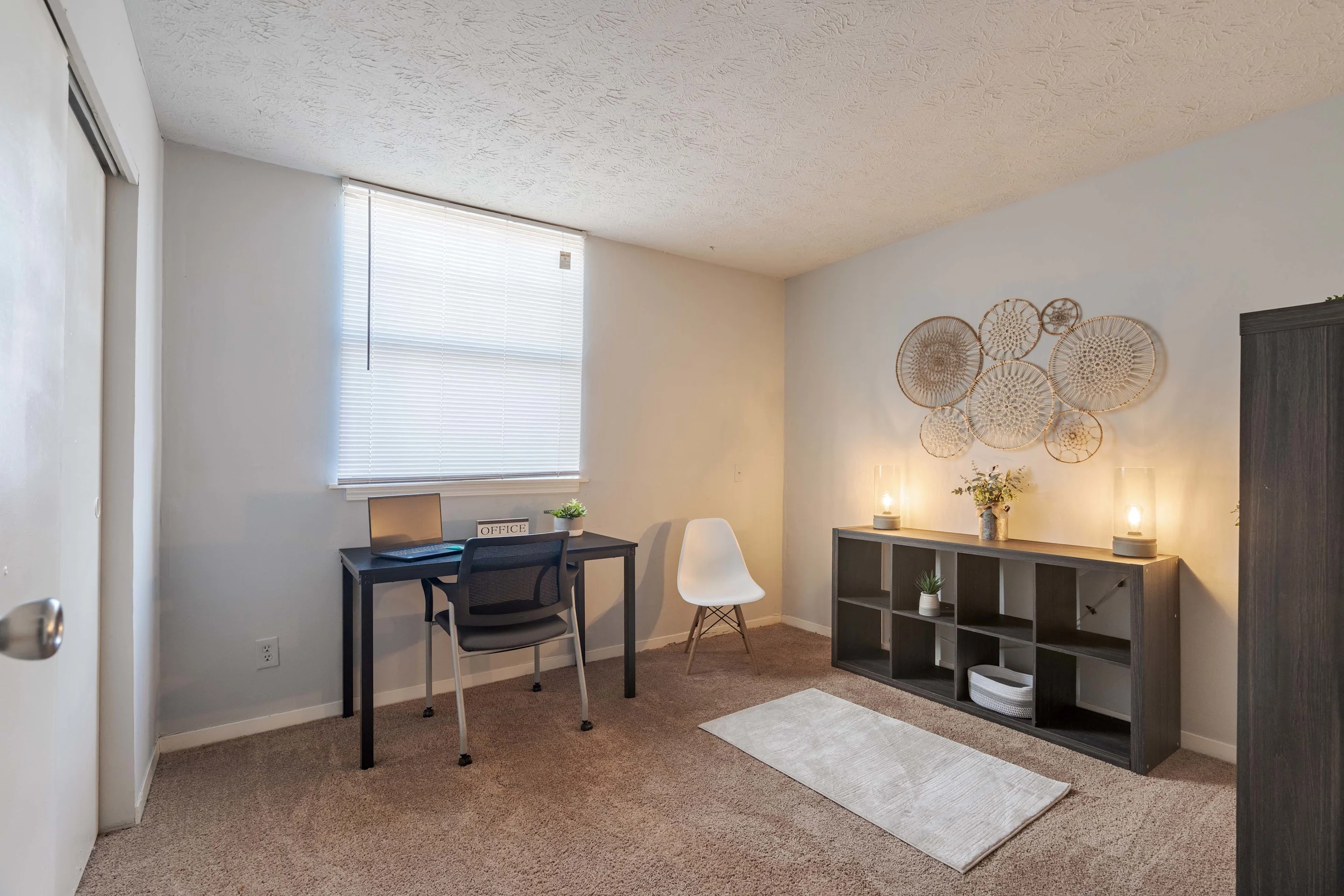 bedroom set up as an office with a desk 