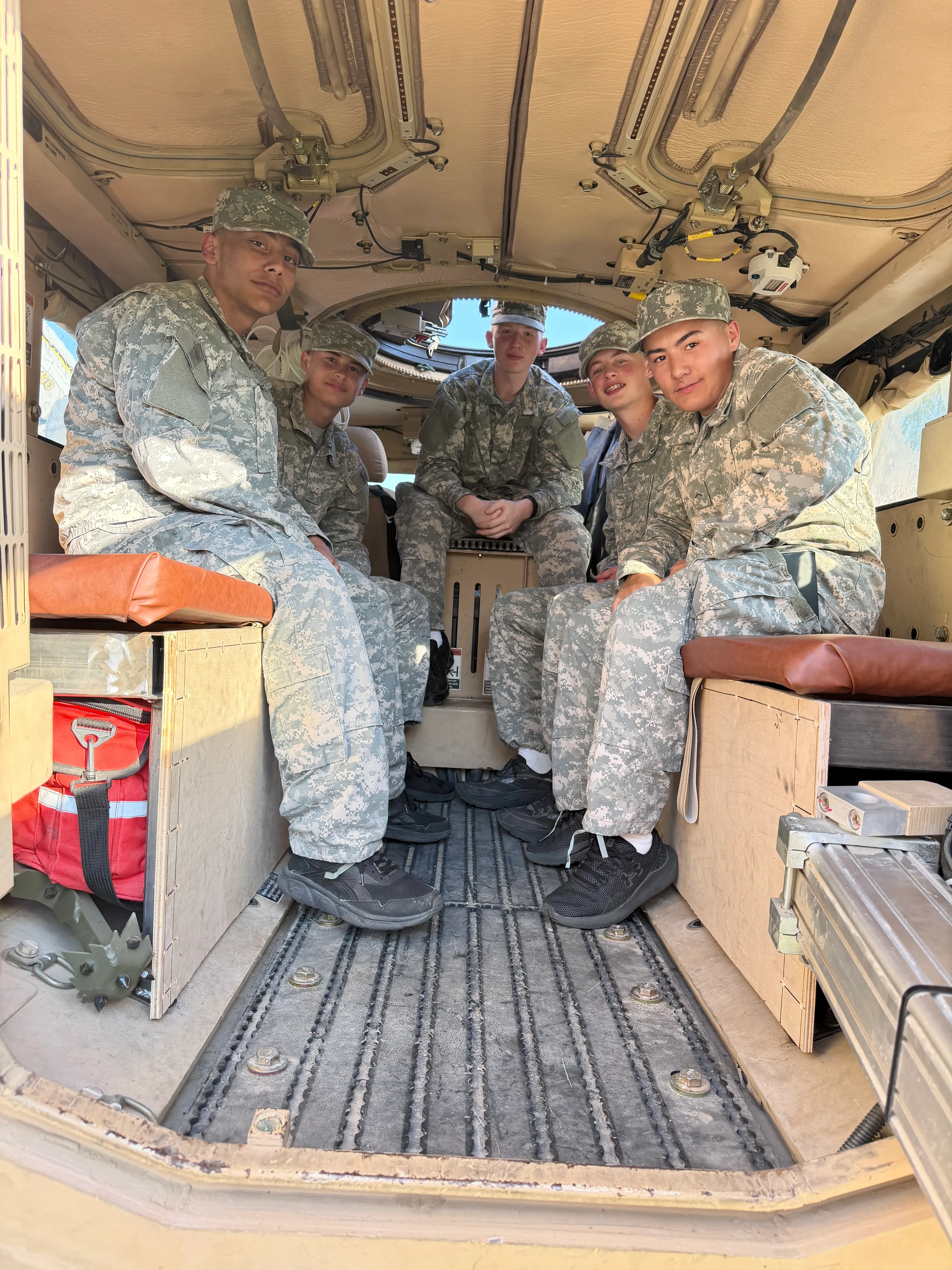 BBYCA cadets seated inside a National Guard vehicle