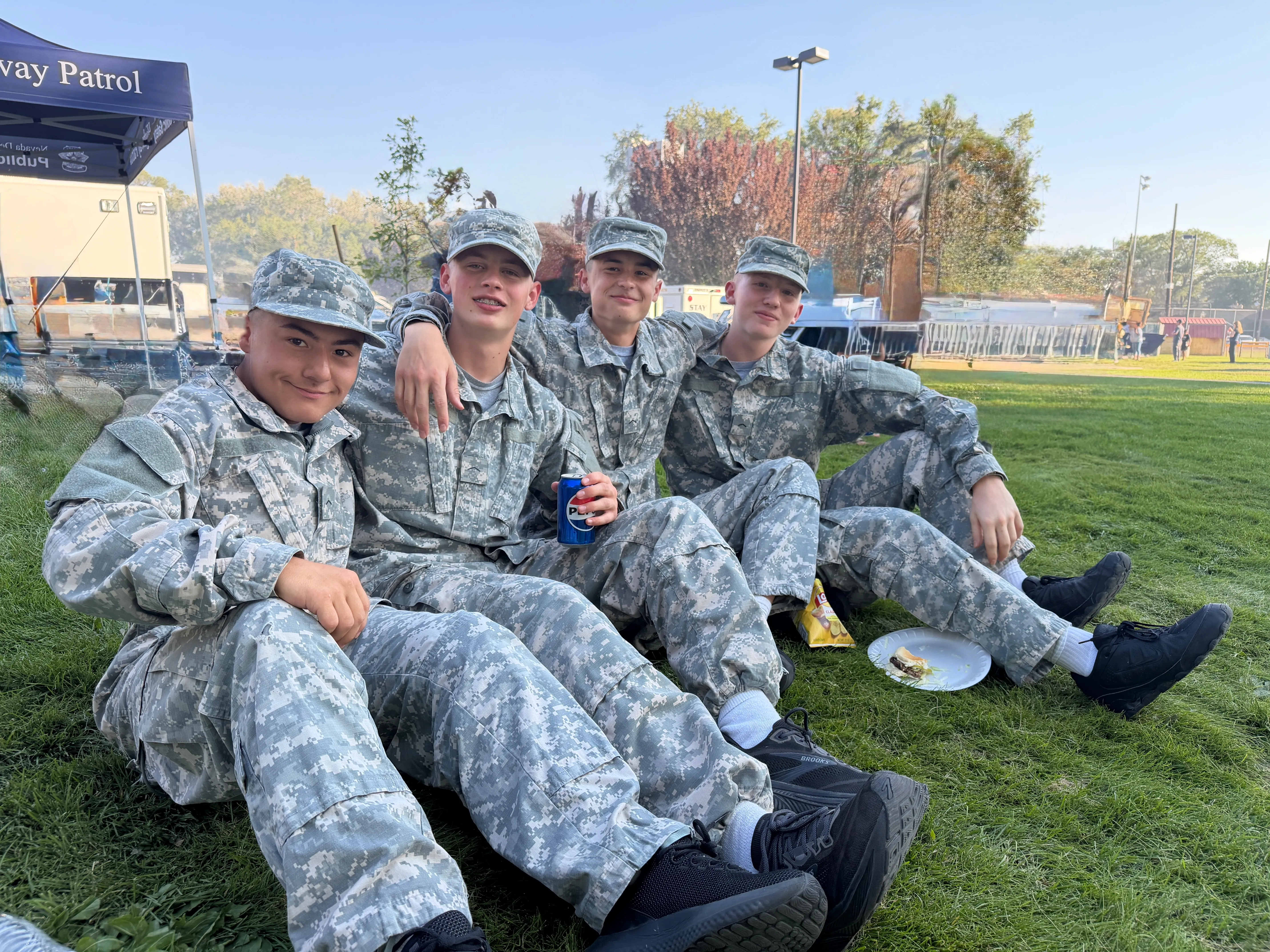 BBYCA cadets relaxing together on the grass at an event