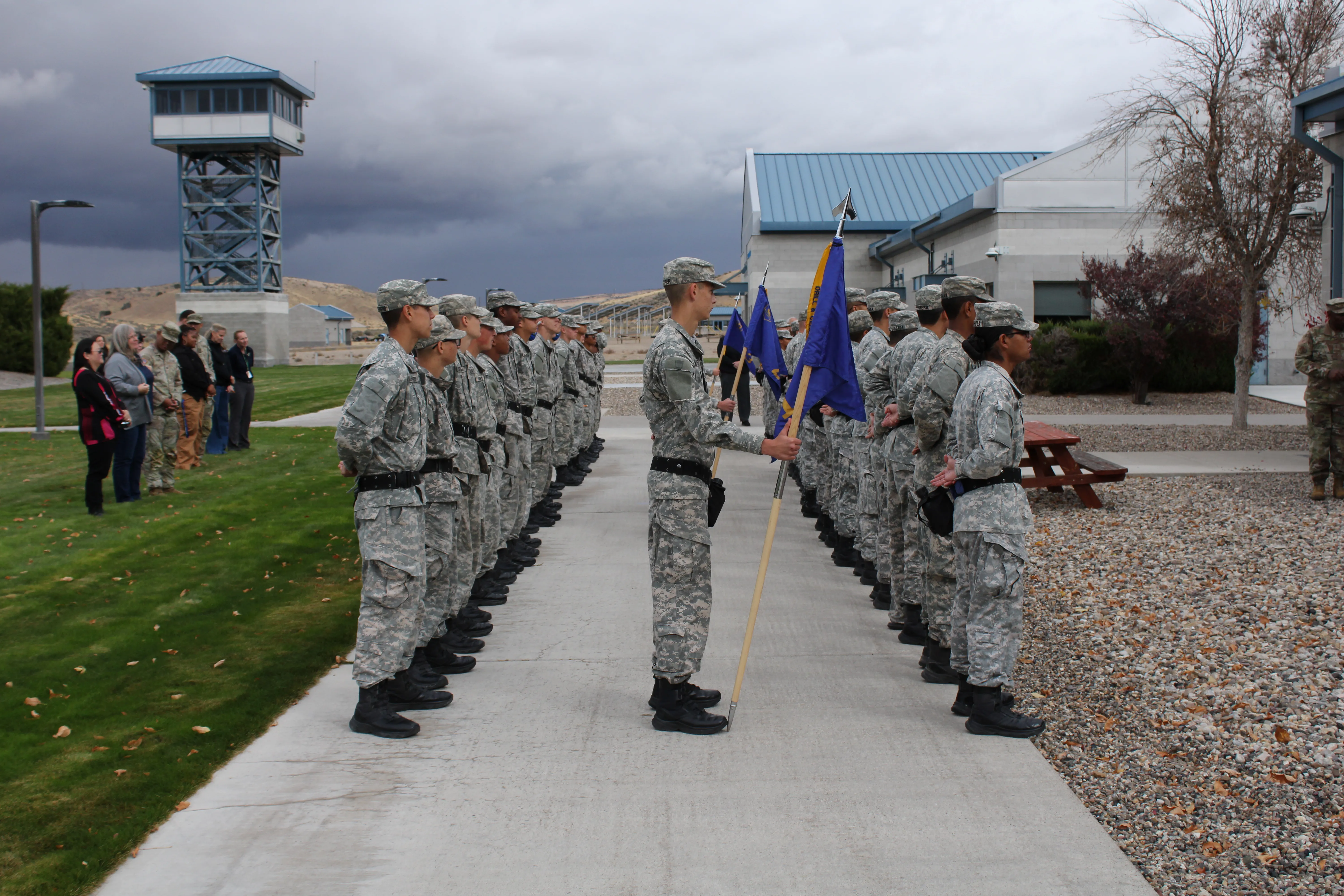 BBYCA cadets standing in formation with guidons on the Carlin, Nevada campus