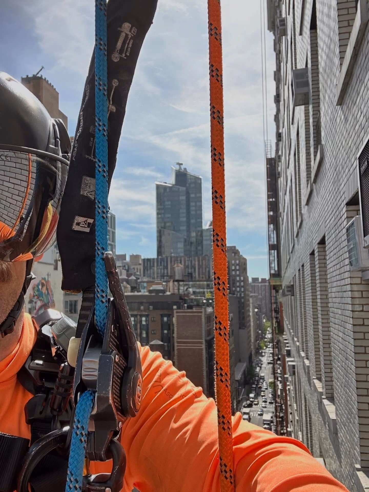 First-person view from the ropes partway down a city building