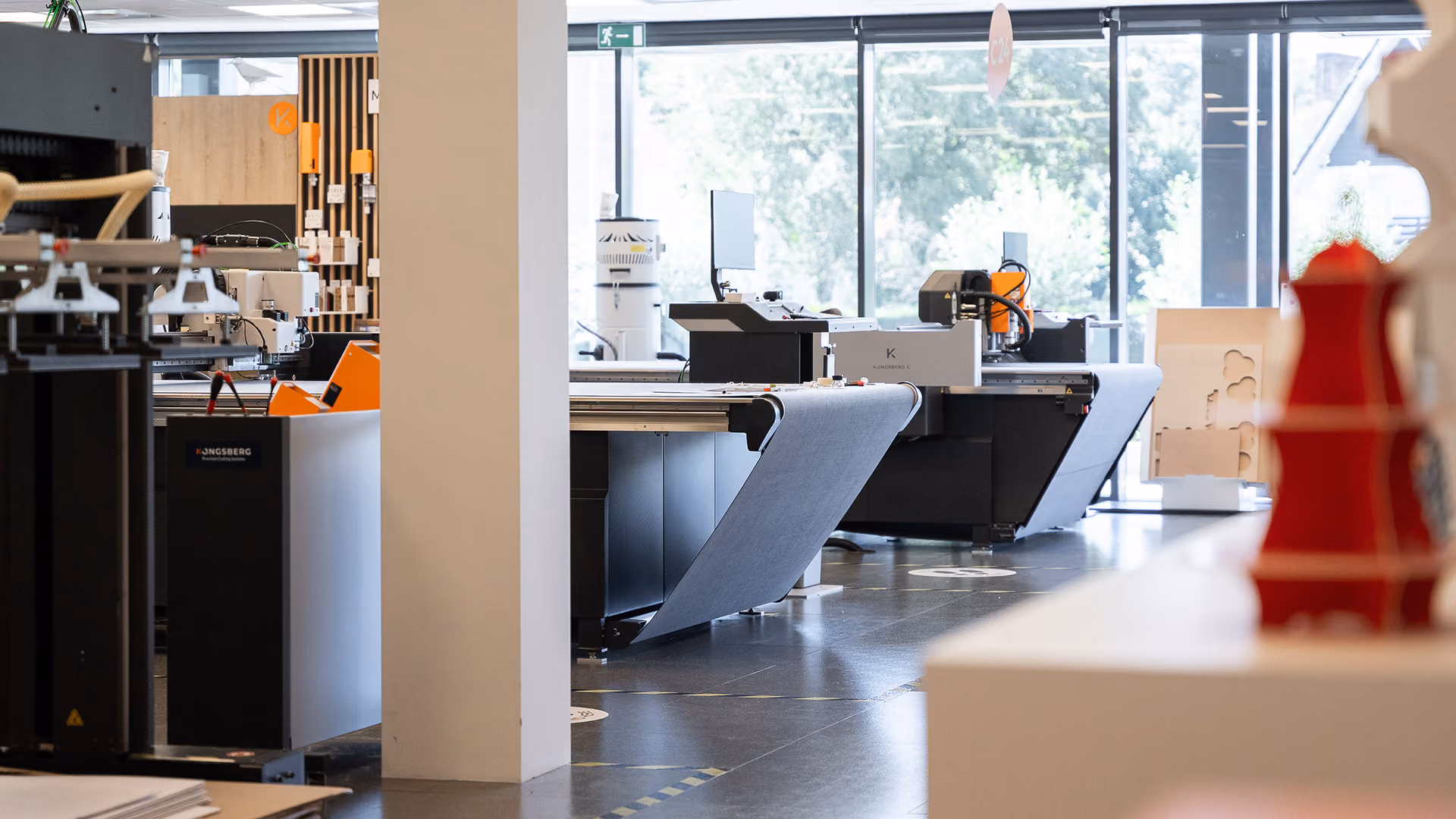 Several Kongsberg PCS cutting tables lined up in the CEC in Ghent (BE)