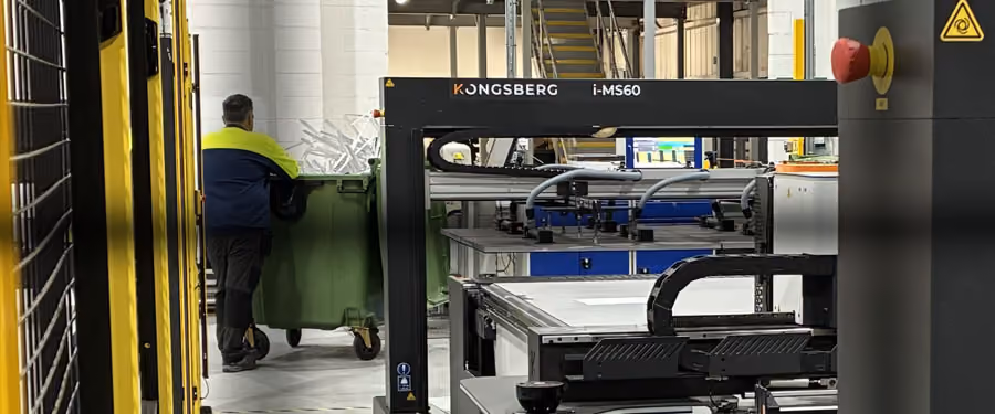 View of a Kongsberg Ultimate 64 through the fencing of the AES