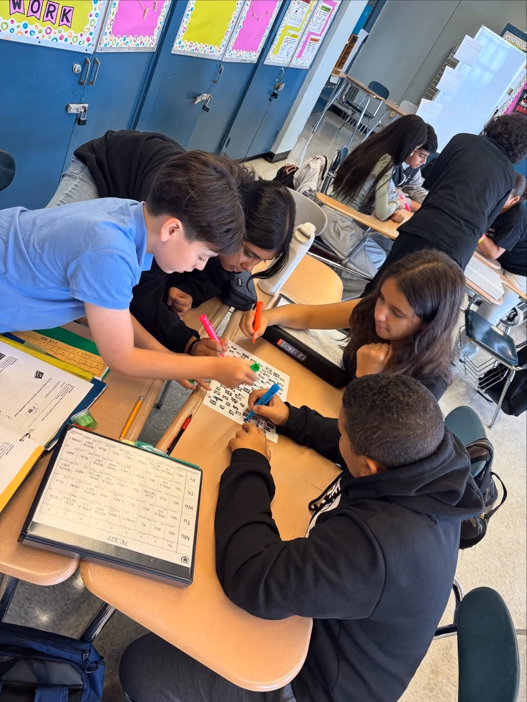 Seventh graders solving problems together at their desks