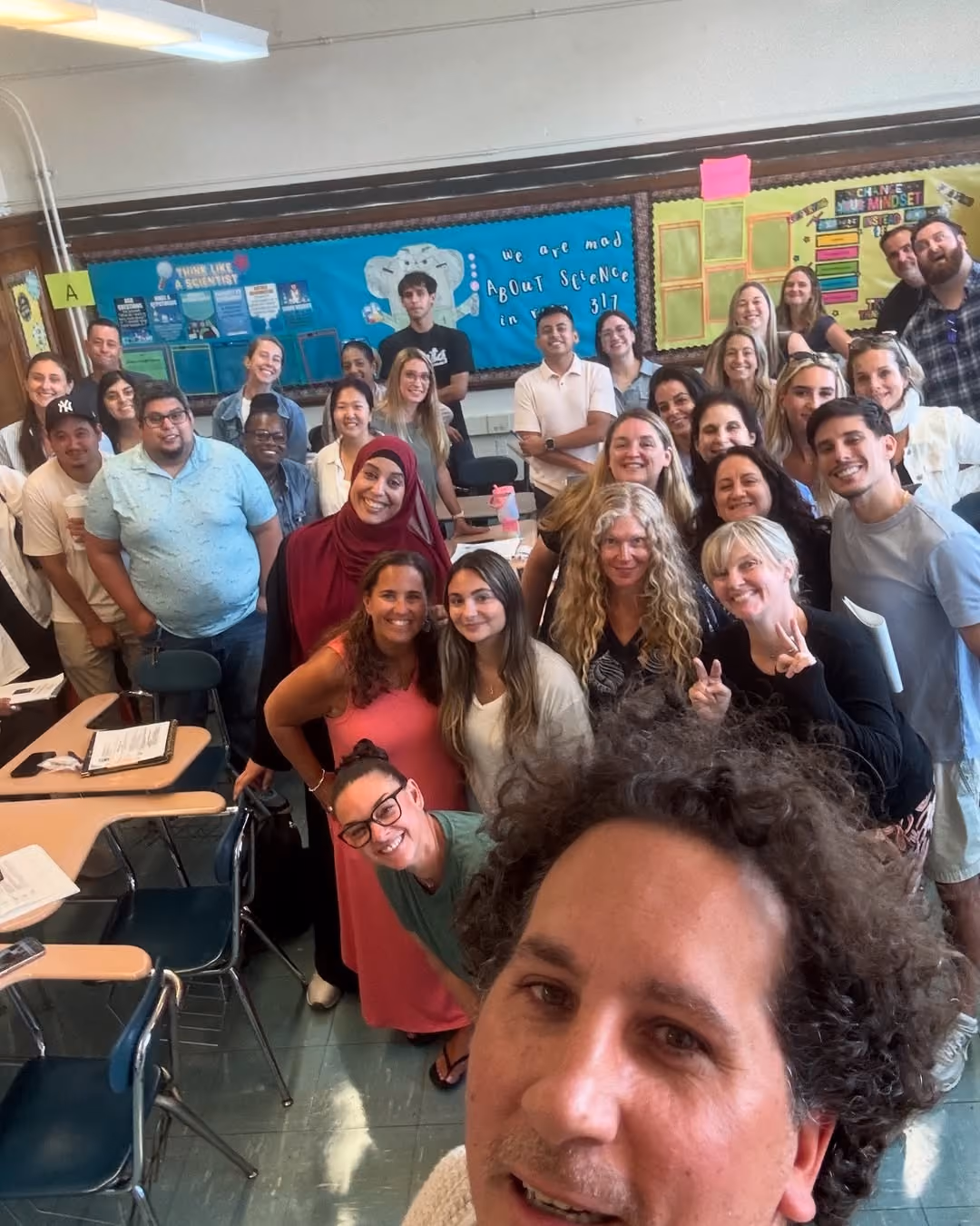 Staff group selfie in a classroom on the first day of the 2025-2026 school year