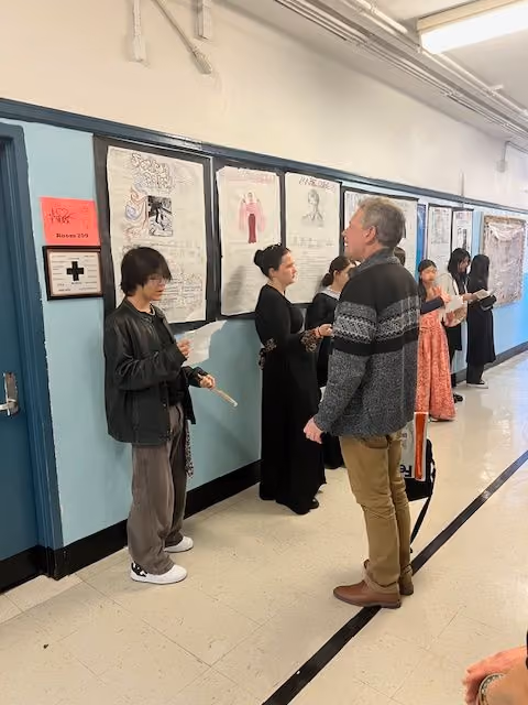 Dr. Fahey talking with a student in costume at the Living Wax Museum
