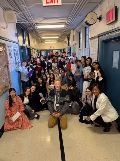 Dr. Fahey with students in costume in the hallway after the Living Wax Museum