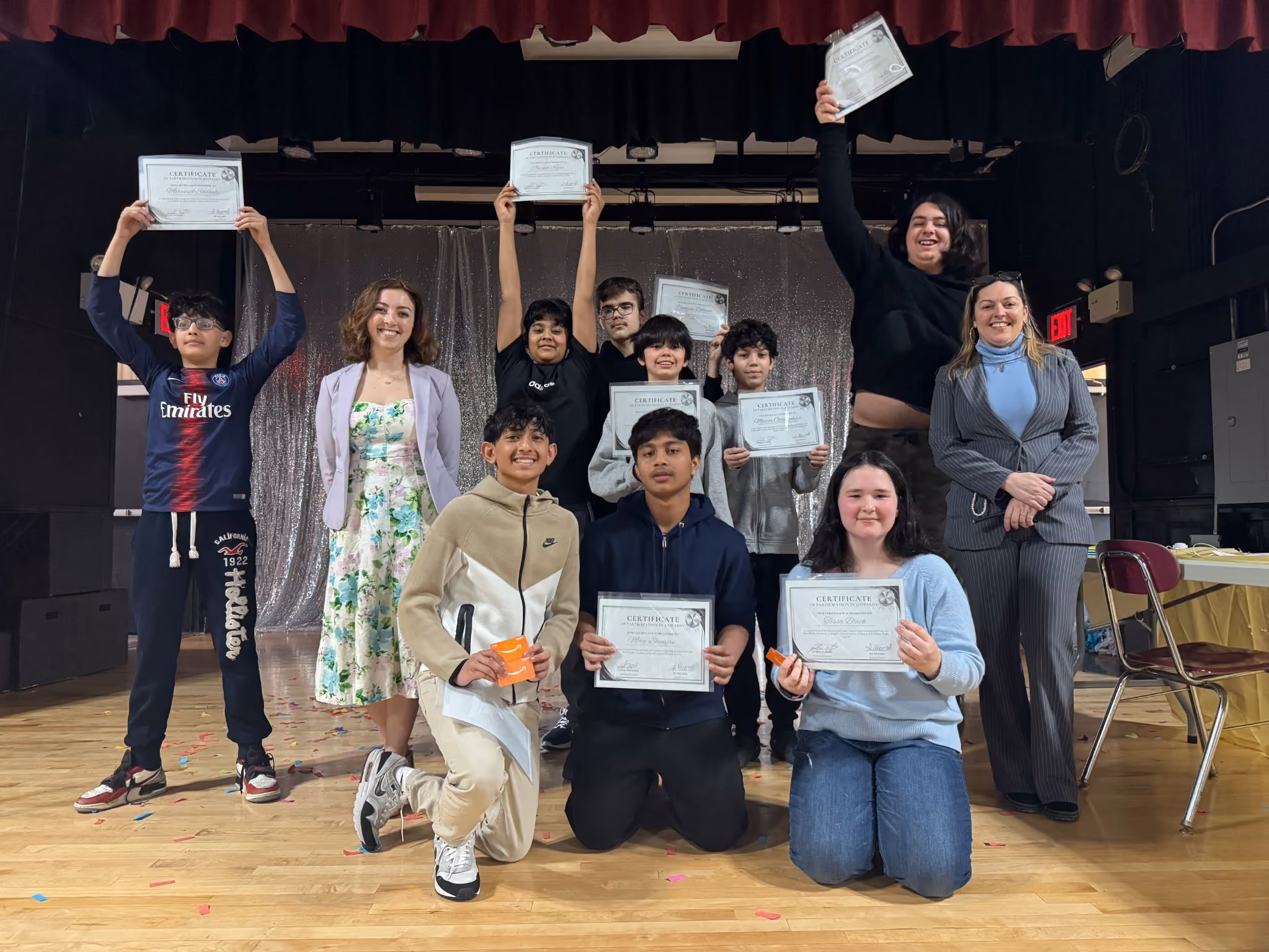 MAA and RBG Jeopardy winners holding certificates on the auditorium stage