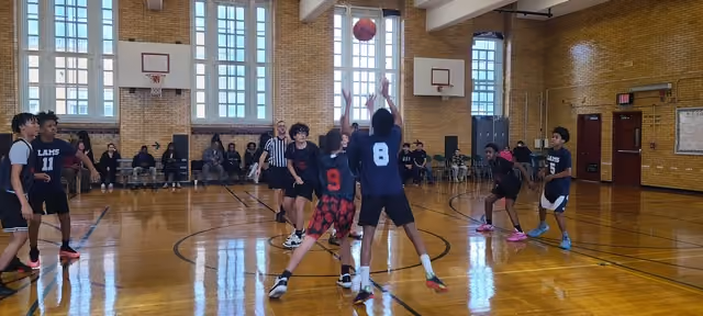 I.S. 141 basketball team playing a game in the school gym