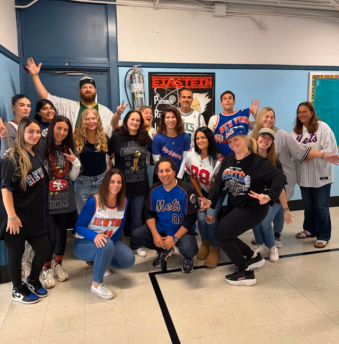 Albert Einstein Academy teachers posing together in sports jerseys