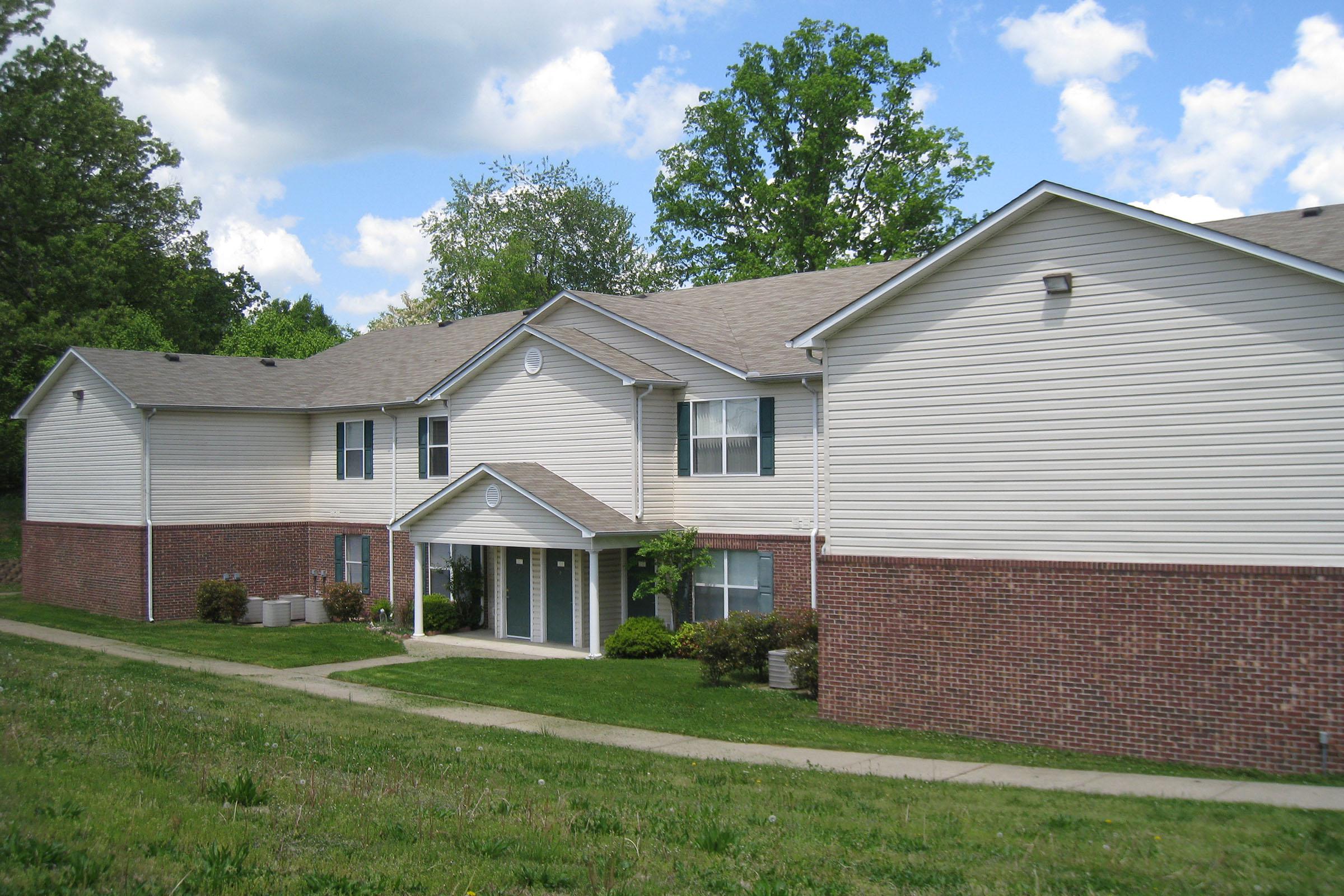 Apartment building side view with walkway to apartment entrance