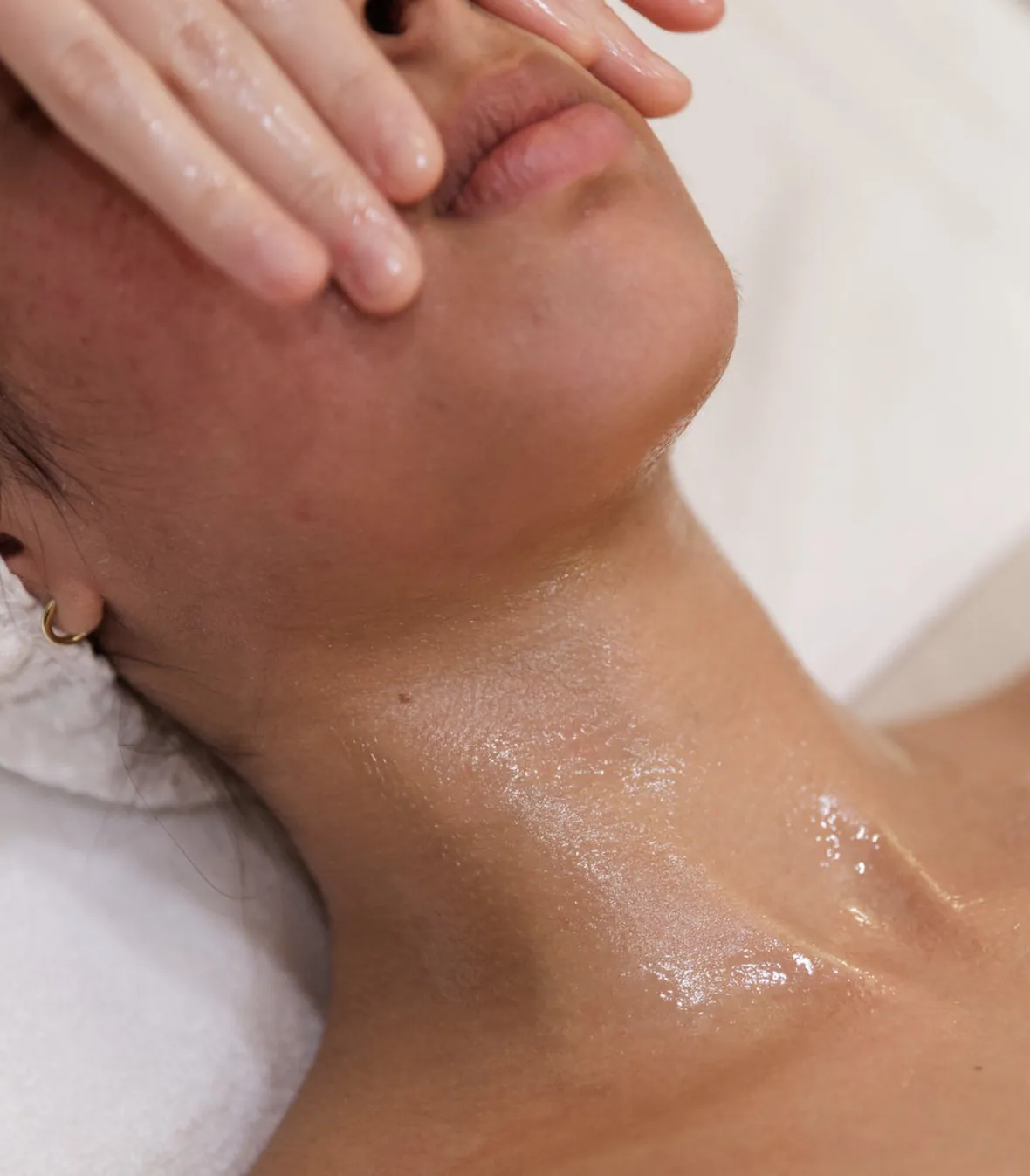 Provider performing laser hair removal on a client's face with a diode laser