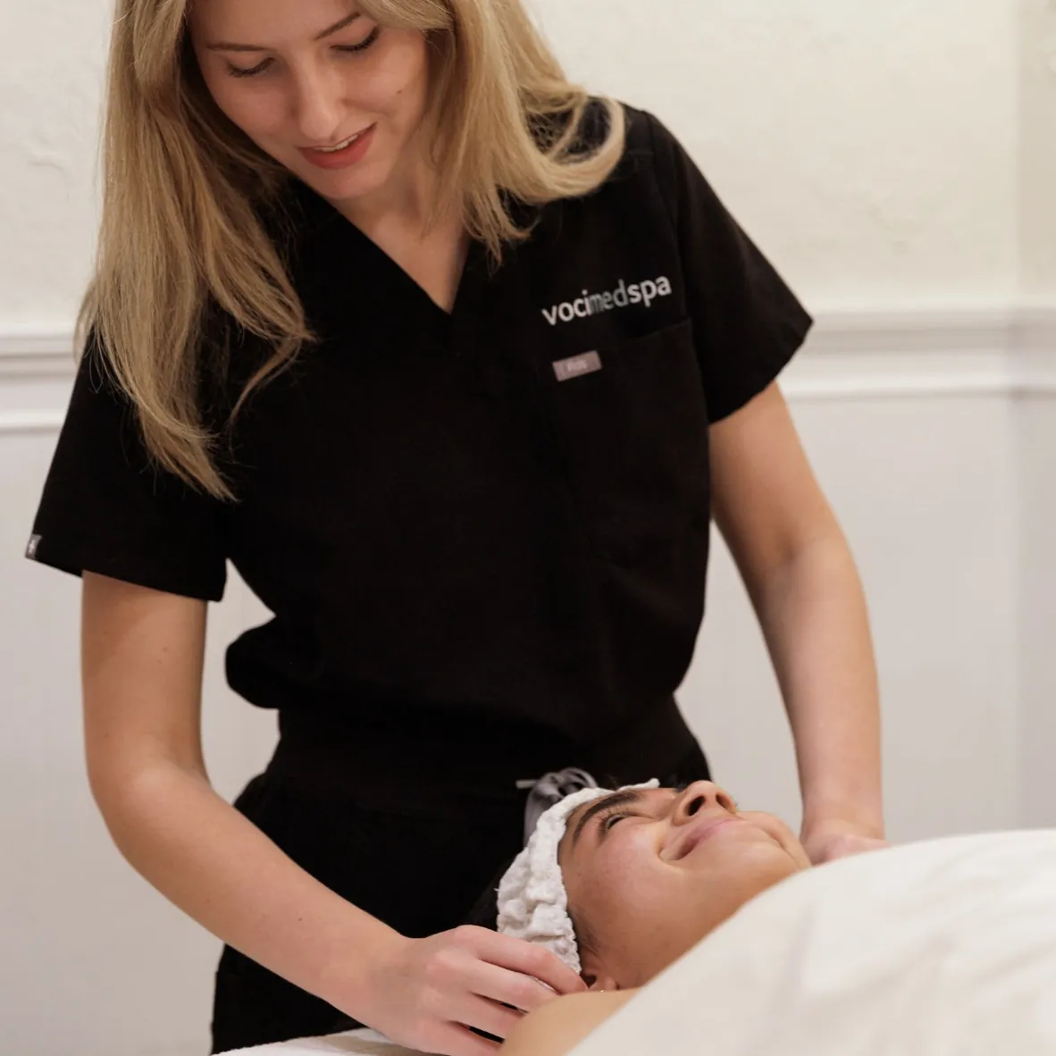 Esthetician shaping a client's brows during a brow appointment