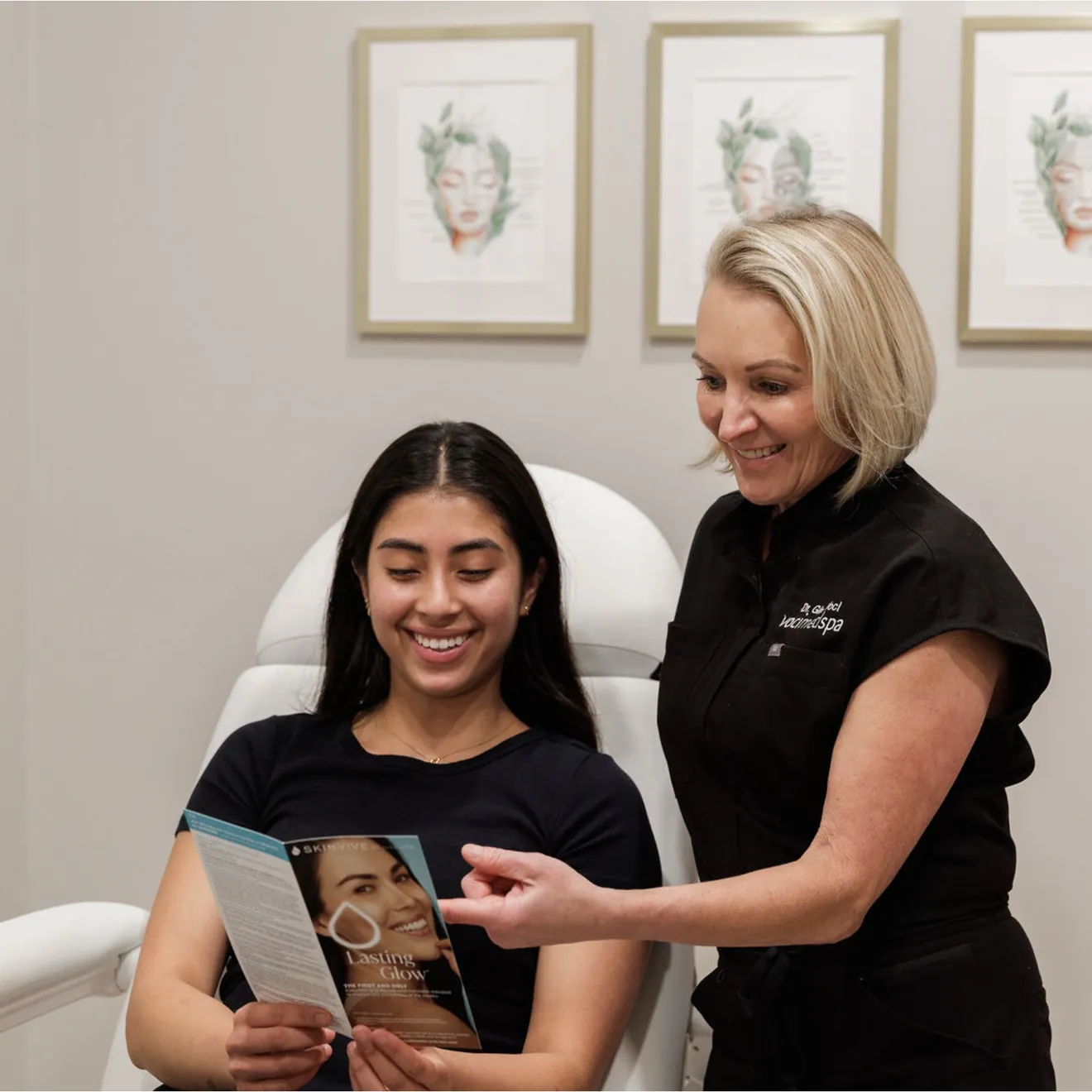 Voci provider walking a smiling client through a treatment brochure