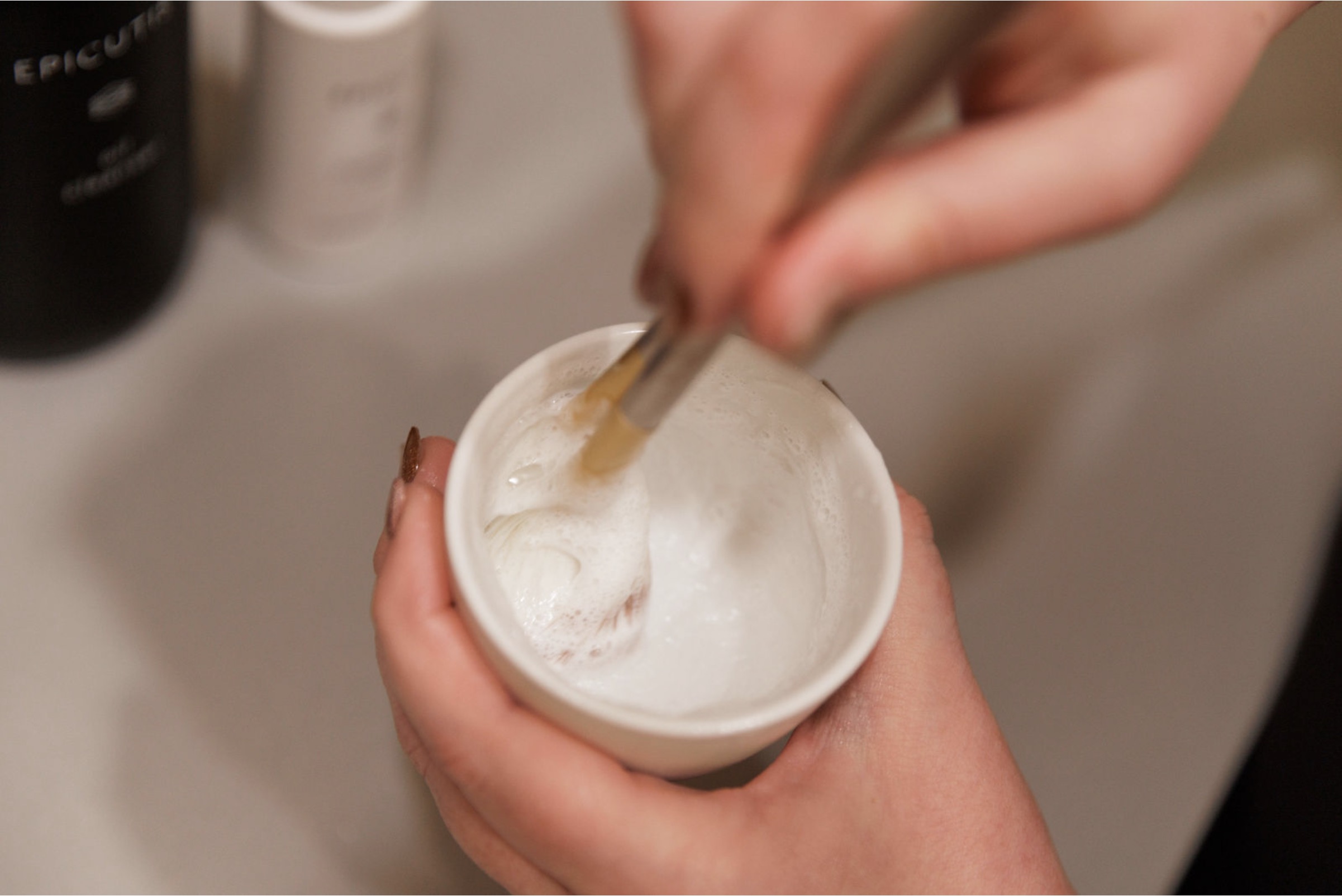 Esthetician mixing a treatment masque