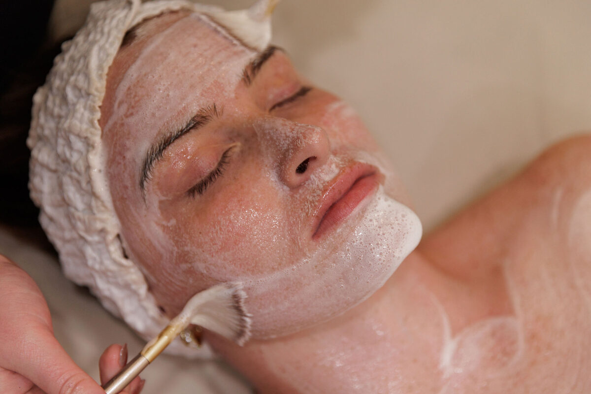 Client receiving a foaming facial treatment